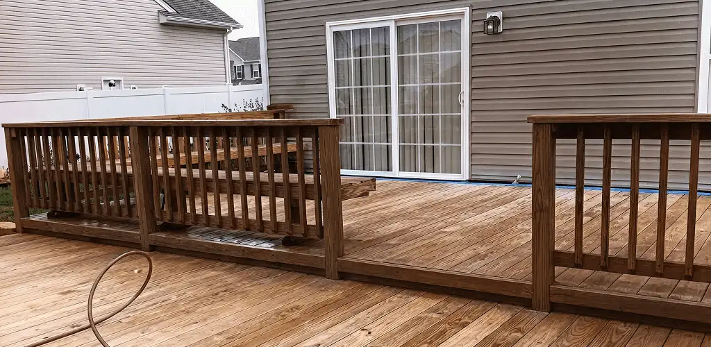 Deck sealing service protecting a backyard wood deck and railings in Tacoma, WA