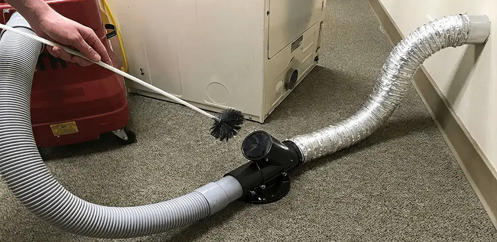 Dryer vent cleaning service removing lint from a dryer duct connection in Tacoma, WA