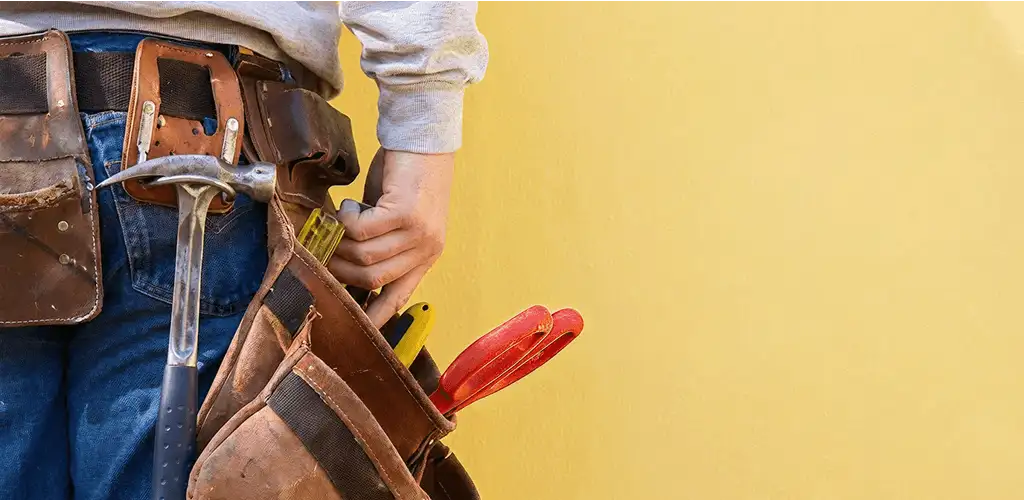 Handyman with tool belt ready for home repairs and maintenance in Tacoma, WA