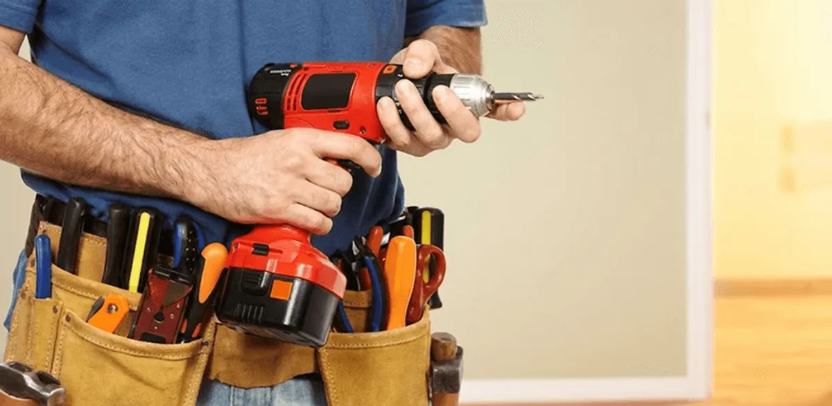 Handyman holding a power drill for home repairs and installations in Tacoma, WA