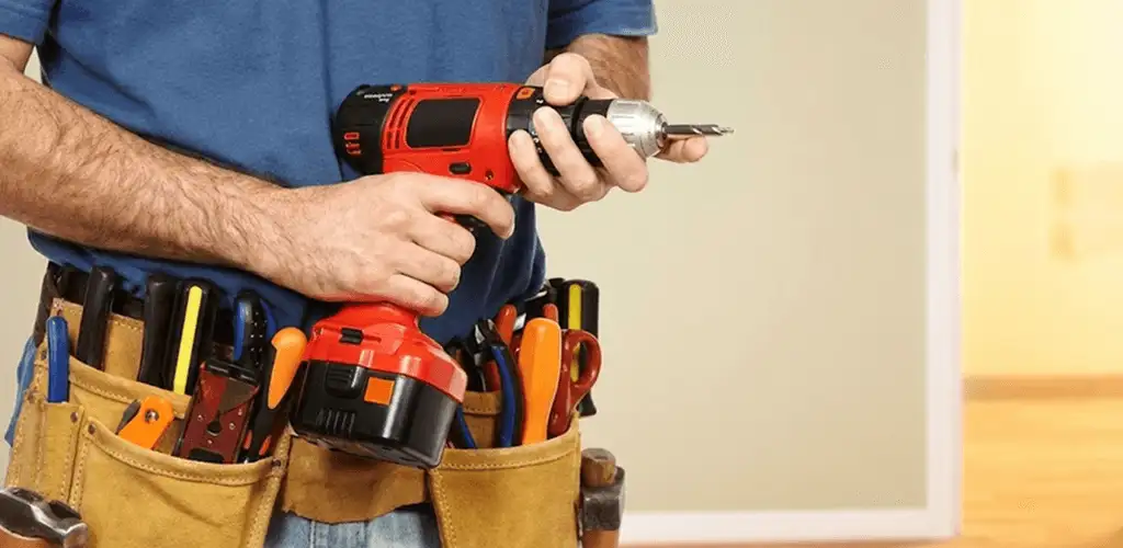 Handyman holding a power drill for home repairs and installations in Tacoma, WA