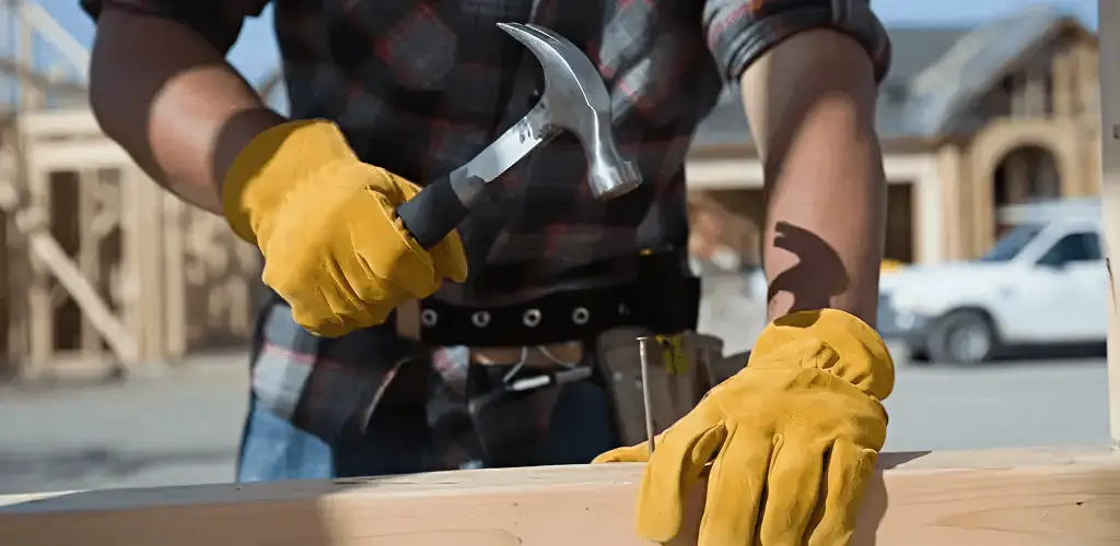 Handyman fixing wood trim with a hammer for home repairs in Tacoma, WA