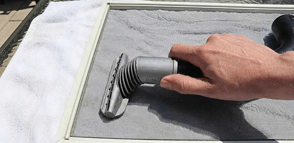 Window screen repair cleaning and fixing a damaged screen mesh in Tacoma, WA